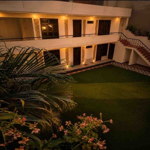Peaceful garden at Rangoli Garden Homestay in Varanasi with lush greenery, relaxing outdoor seating, and a tranquil atmosphere.